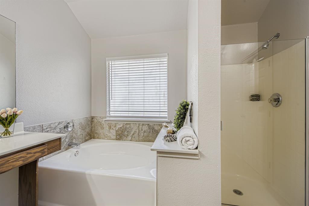 4201 Broken Bend Boulevard Fort Worth, TX 76244 - Photo 18 of 34 a bathroom with a sink a window and tub