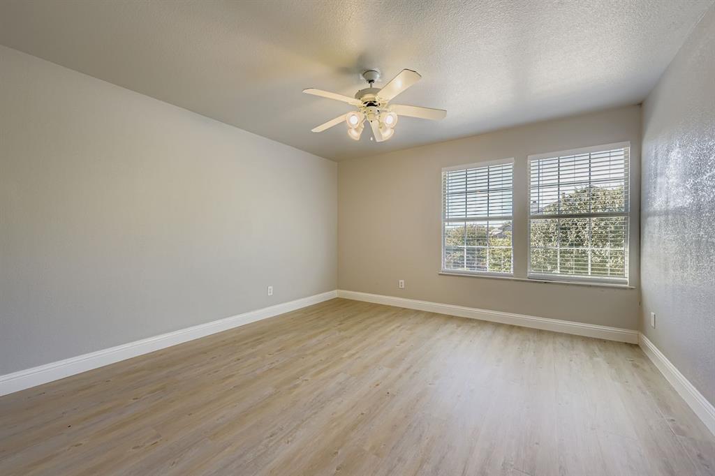 4201 Broken Bend Boulevard Fort Worth, TX 76244 - Photo 20 of 34 an empty room with wooden floor fan and windows