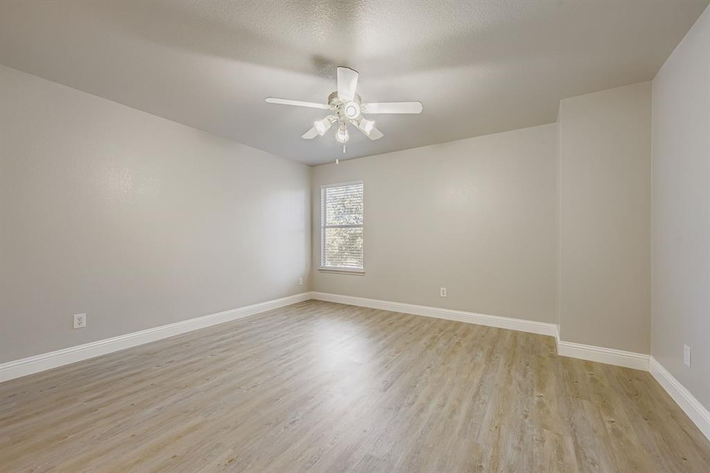 4201 Broken Bend Boulevard Fort Worth, TX 76244 - Photo 23 of 34 an empty room with wooden floor and windows
