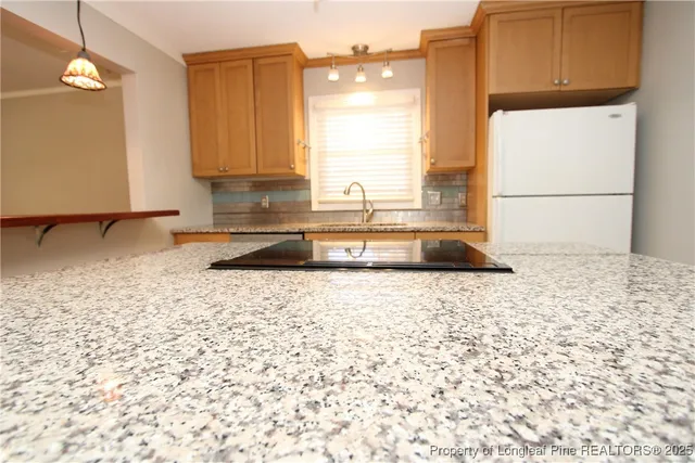 a view of a kitchen with a sink and cabinets