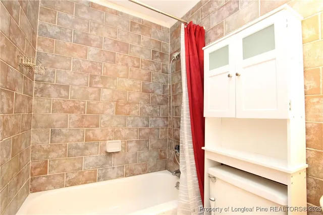 a bathroom with a bathtub and shower