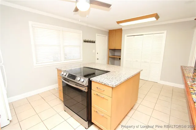a kitchen with granite countertop a stove a sink and a microwave