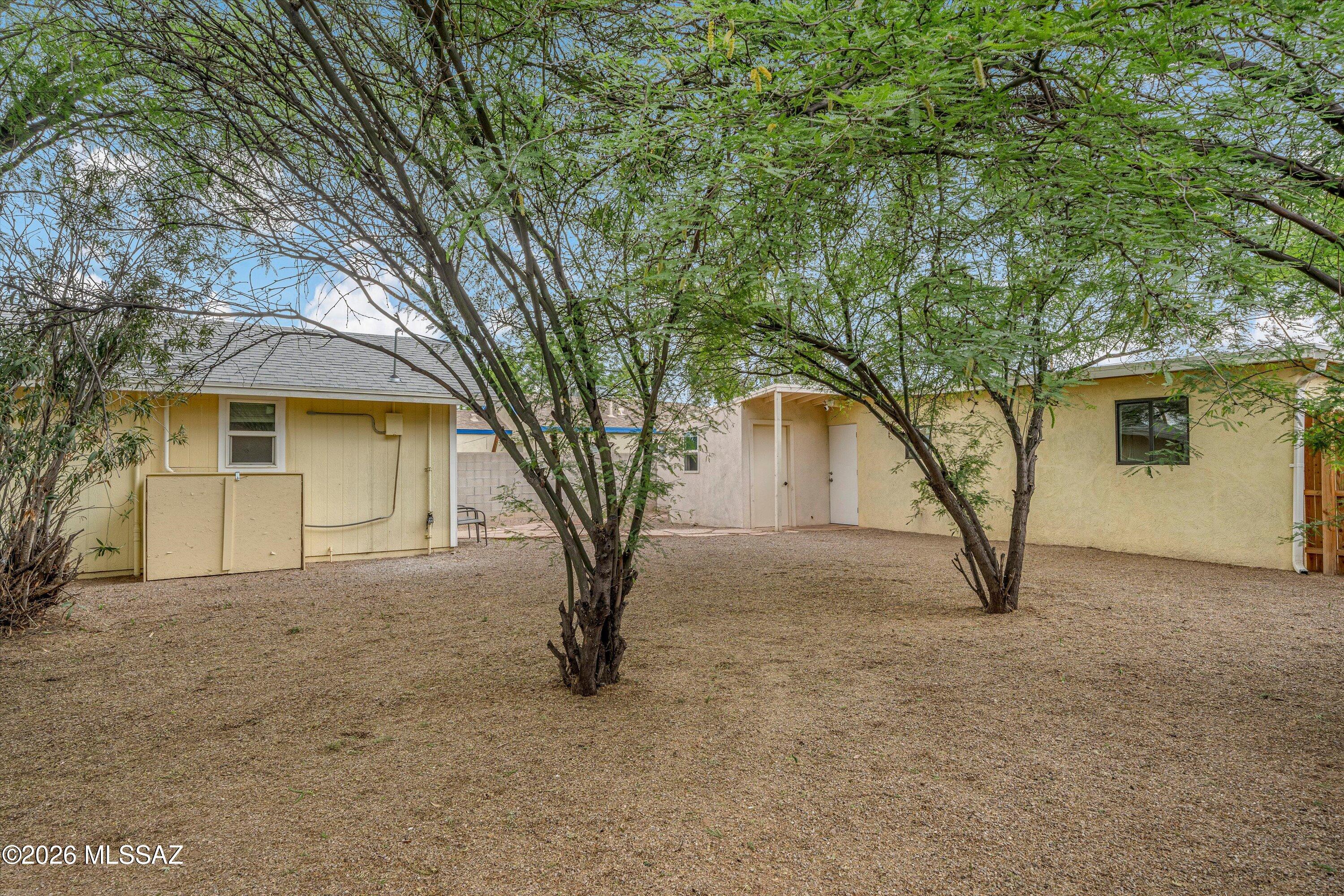 2841 North Richey Boulevard Tucson, AZ 85716 - Photo 24 of 30 a white house that has a tree in front of it