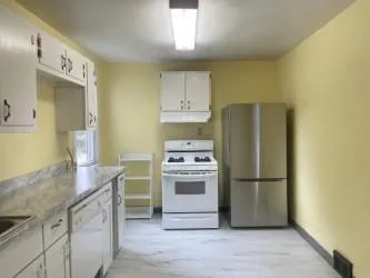 a kitchen with a refrigerator sink and stove