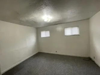 an empty room with a empty space and windows