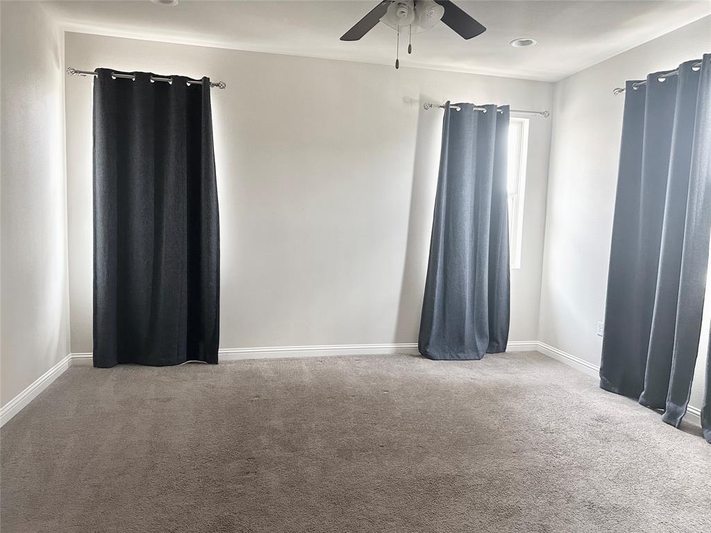 6814 East Riverside Drive, Unit 26 Austin, TX 78741 - Photo 9 of 21 Well-lit room provides a comfortable and versatile living space for various needs.