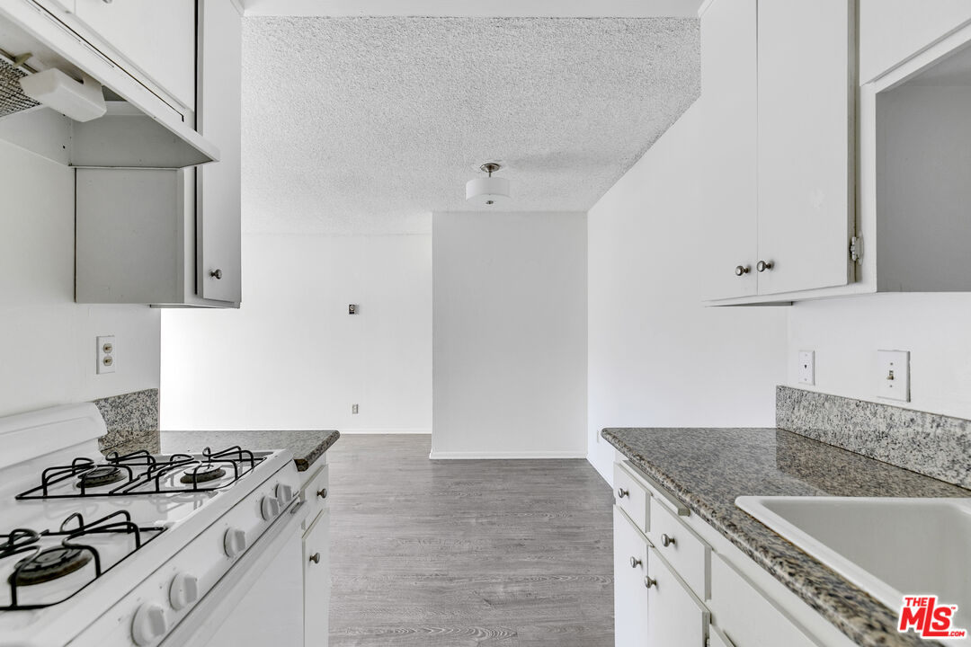 1811 Parnell Avenue, Unit 3 Los Angeles, CA 90025 - Photo 11 of 20 a kitchen with granite countertop a sink stove and cabinets