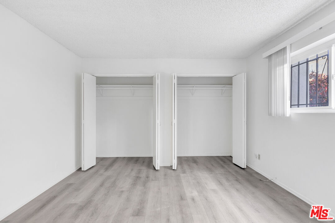 1811 Parnell Avenue, Unit 3 Los Angeles, CA 90025 - Photo 14 of 20 an empty room with wooden floor and windows