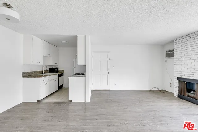 a kitchen with a cabinets and white appliances