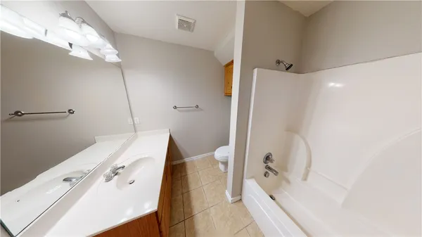 a bathroom with a tub and a shower