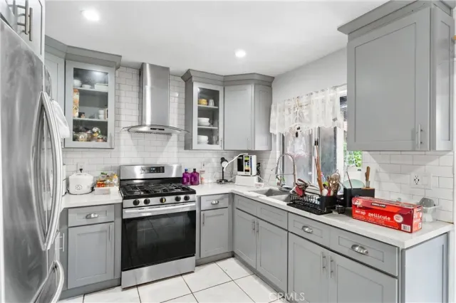 a kitchen with stainless steel appliances a sink stove and refrigerator