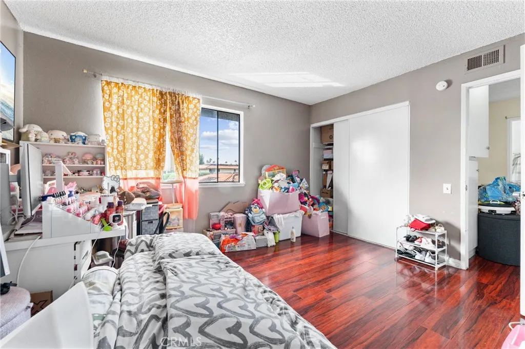 3927 West McFadden Avenue Santa Ana, CA 92704 - Photo 8 of 14 a living room filled with furniture and a wooden floor