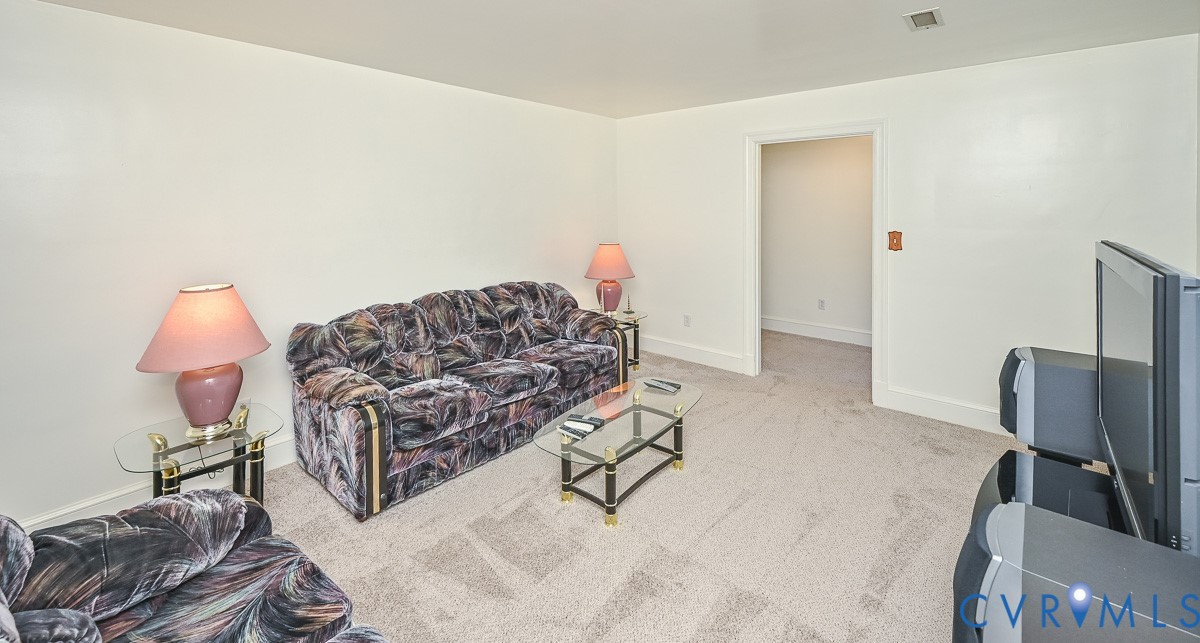 620 Three Chopt Road Manakin-Sabot, VA 23103 - Photo 33 of 42 a living room with furniture a couch and a flat screen tv