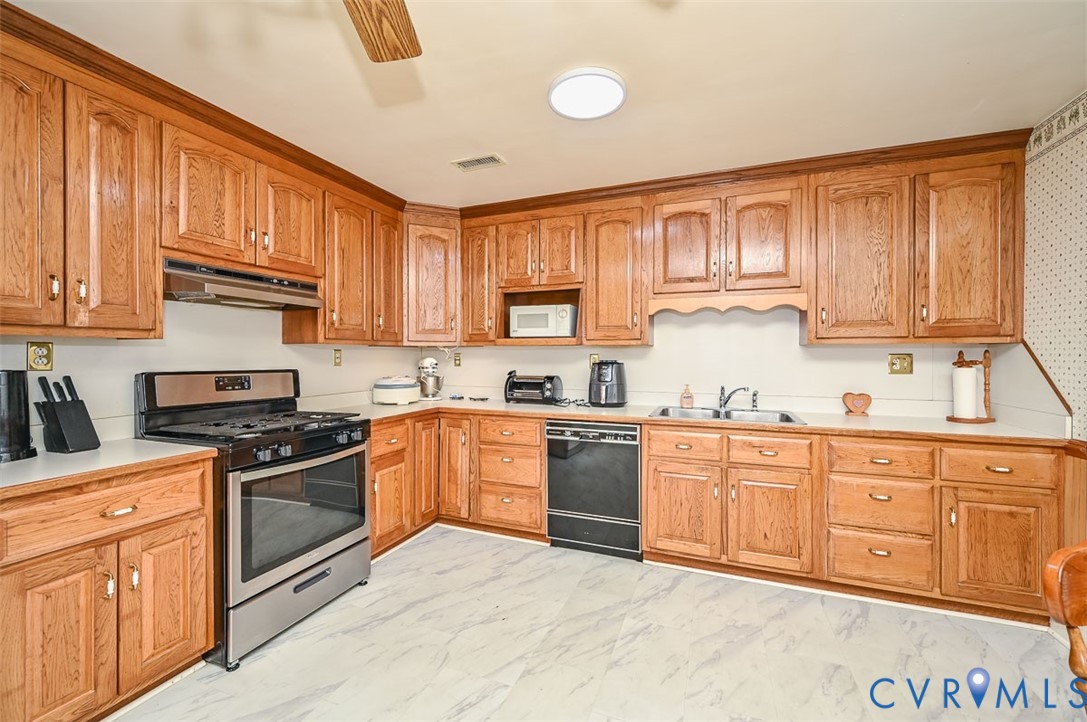 620 Three Chopt Road Manakin-Sabot, VA 23103 - Photo 9 of 42 a kitchen with stainless steel appliances granite countertop a stove sink and cabinets
