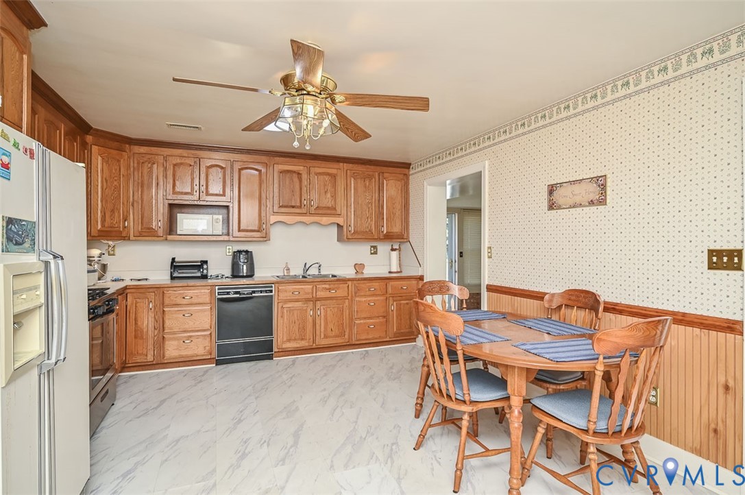 620 Three Chopt Road Manakin-Sabot, VA 23103 - Photo 10 of 42 a kitchen with a table chairs stove and cabinets