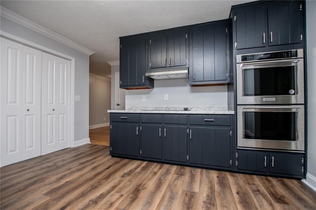 8291 Highway 5 Winston, GA 30187 - Photo 25 of 65 a kitchen with wooden cabinets and a stove top oven