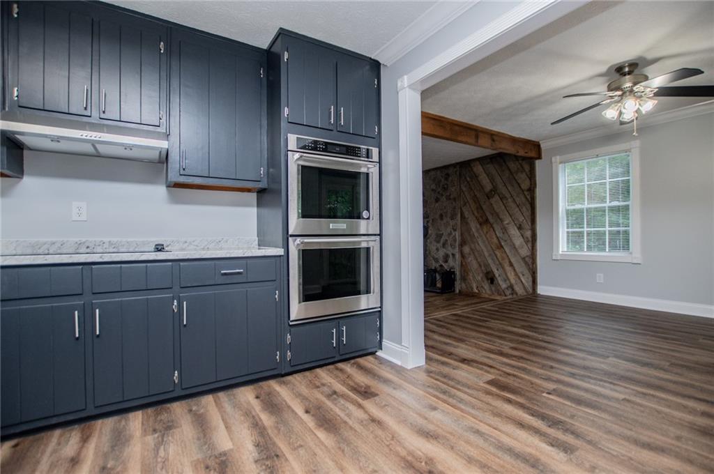8291 Highway 5 Winston, GA 30187 - Photo 26 of 65 a view of a kitchen with furniture and a ceiling fan