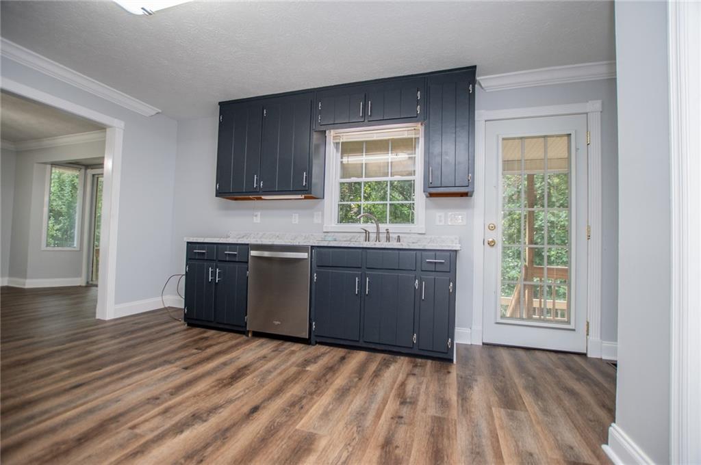 8291 Highway 5 Winston, GA 30187 - Photo 31 of 65 a kitchen with granite countertop a stove a sink and a window