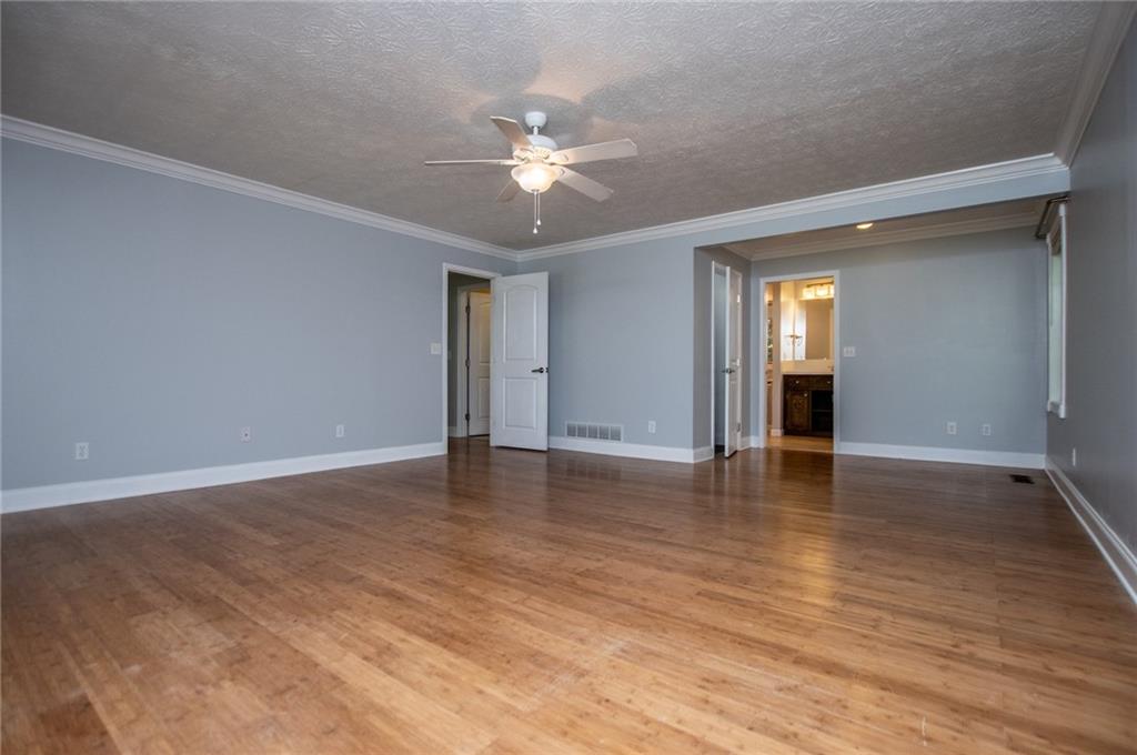 8291 Highway 5 Winston, GA 30187 - Photo 35 of 65 a view of an empty room with wooden floor and a ceiling fan