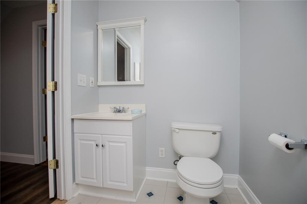 8291 Highway 5 Winston, GA 30187 - Photo 49 of 65 a bathroom with a toilet a sink and mirror