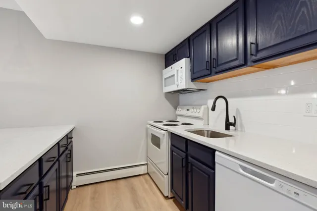 a kitchen with a sink cabinets and stainless steel appliances
