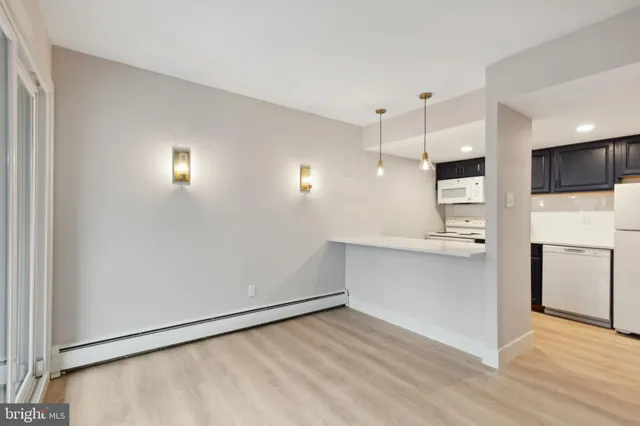 a view of kitchen with wooden floor and electronic appliances