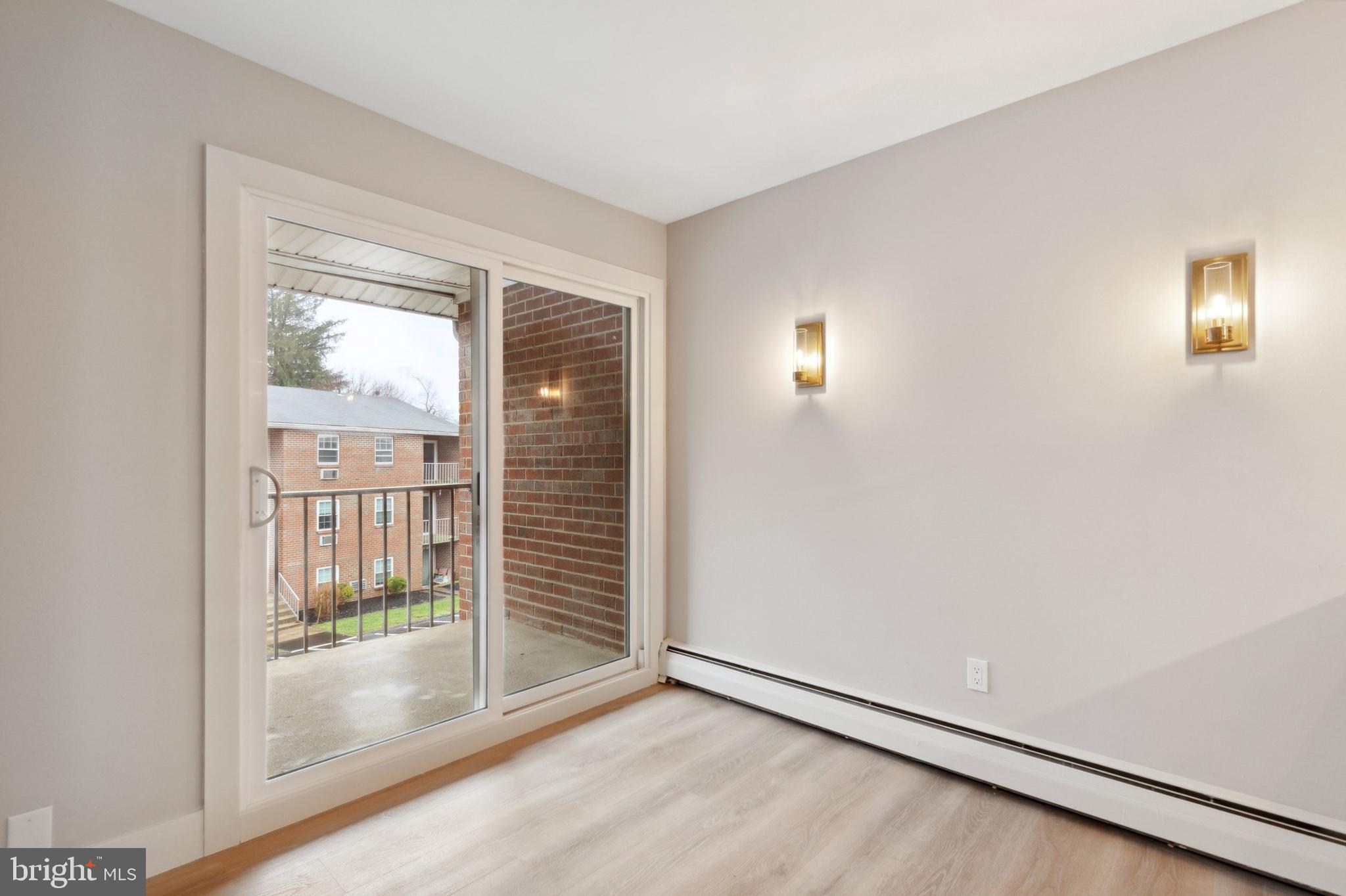 176 West King Street, Unit 311 Malvern, PA 19355 - Photo 5 of 9 an empty room with windows