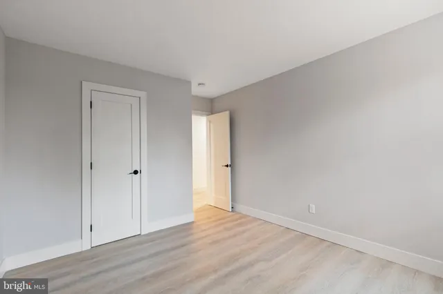 a view of an empty room and wooden floor