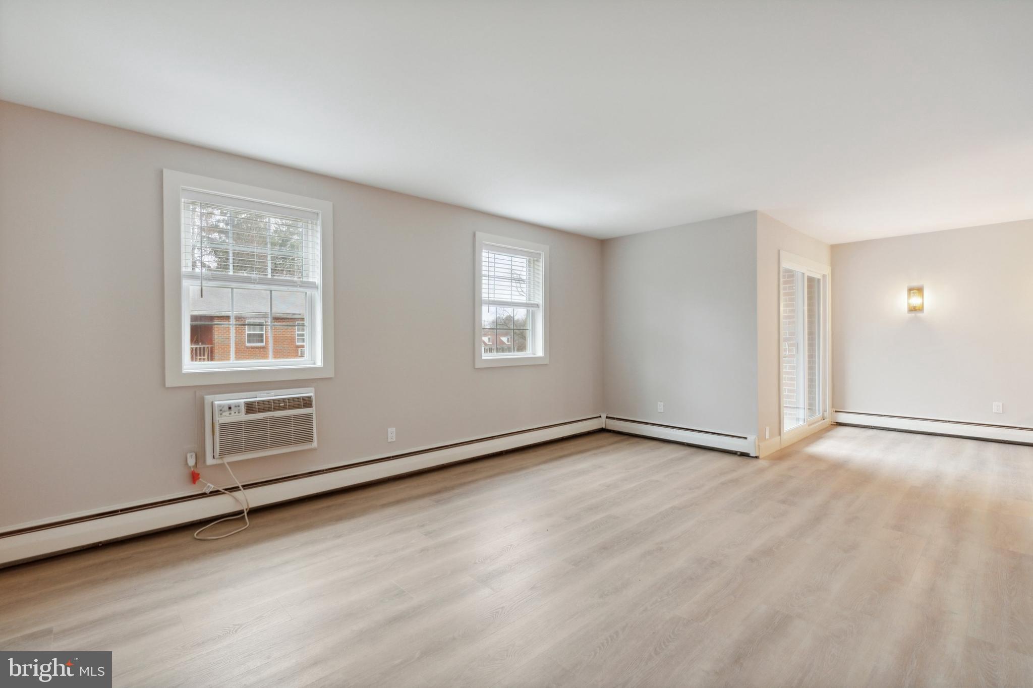 176 West King Street, Unit 311 Malvern, PA 19355 - Photo 8 of 9 an empty room with windows