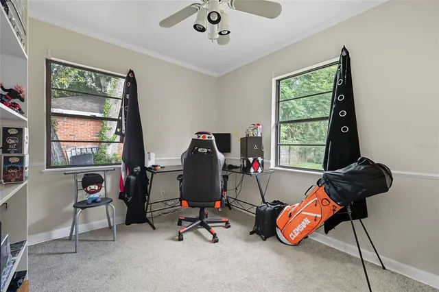 a view of a workspace with furniture and a window