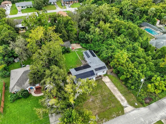 a backyard of a house with lots of green space and garden