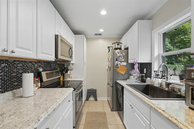 a kitchen that has a sink and a stove