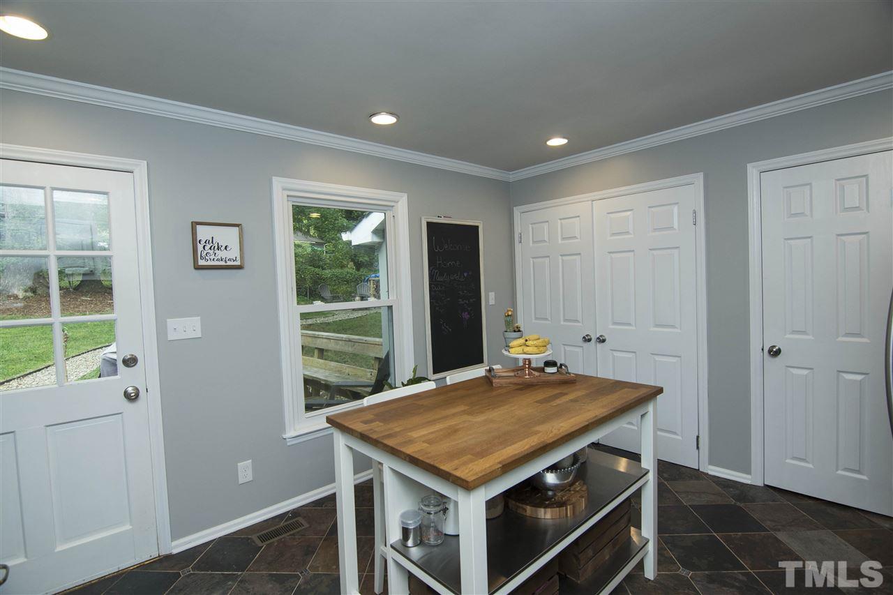 7408 Post Oak Road Raleigh, NC 27615 - Photo 14 of 27 a kitchen with a stove and a refrigerator