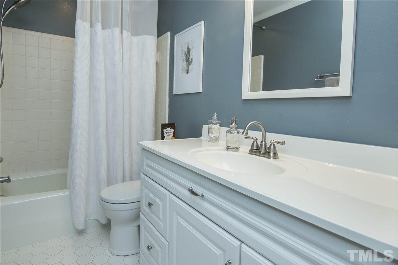 7408 Post Oak Road Raleigh, NC 27615 - Photo 22 of 27 a bathroom with a sink toilet and shower