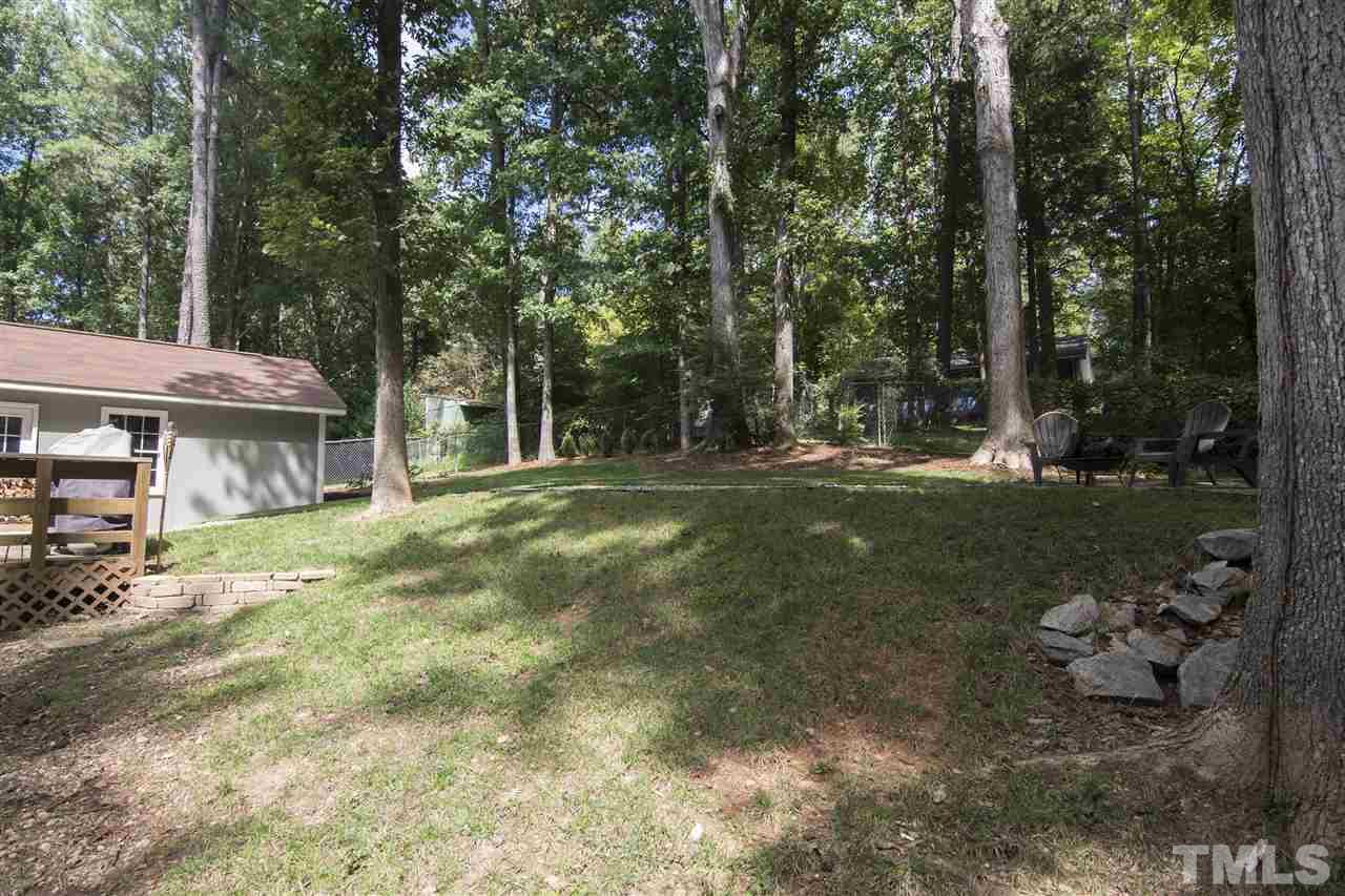 7408 Post Oak Road Raleigh, NC 27615 - Photo 5 of 27 a backyard of a house with table and chairs