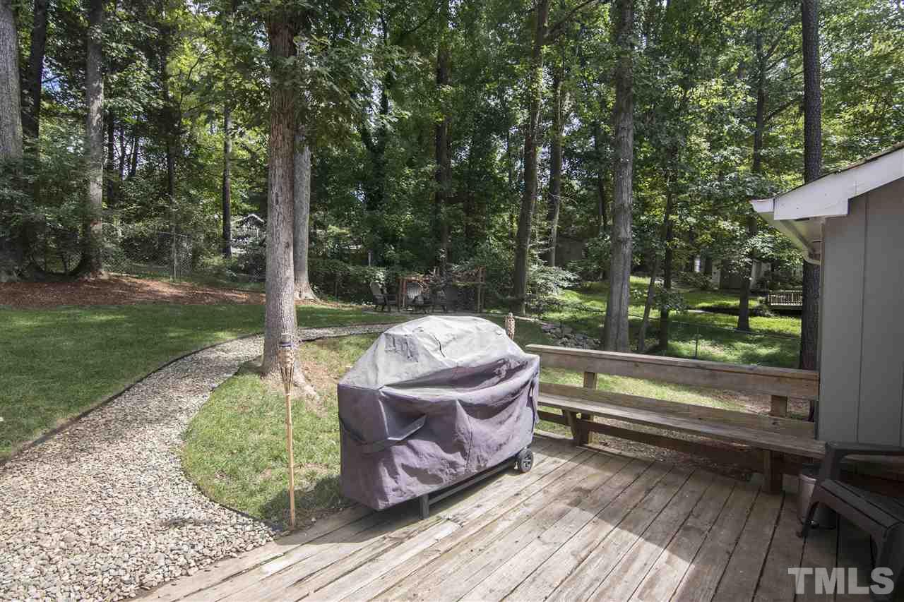 7408 Post Oak Road Raleigh, NC 27615 - Photo 9 of 27 a view of a wooden deck next to a yard