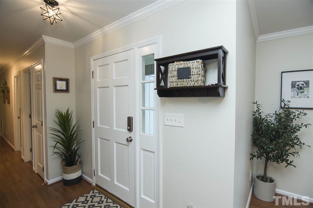 7408 Post Oak Road Raleigh, NC 27615 - Photo 10 of 27 a view of a hallway with potted plant and a potted plant
