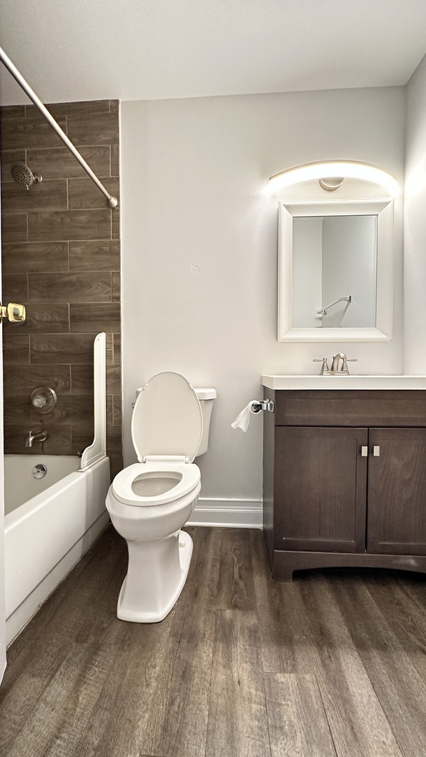 2014 North Rand Road, Unit 108 Palatine, IL 60074 - Photo 14 of 16 a bathroom with a toilet sink and mirror