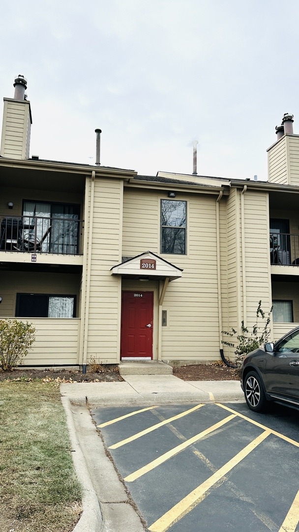 2014 North Rand Road, Unit 108 Palatine, IL 60074 - Photo 2 of 16 a view of a car park in front of a house