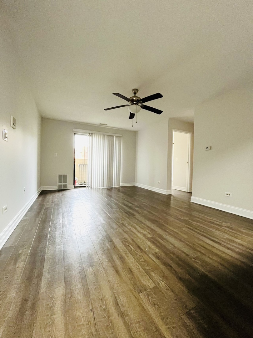 2014 North Rand Road, Unit 108 Palatine, IL 60074 - Photo 5 of 16 a view of an empty room and wooden floor