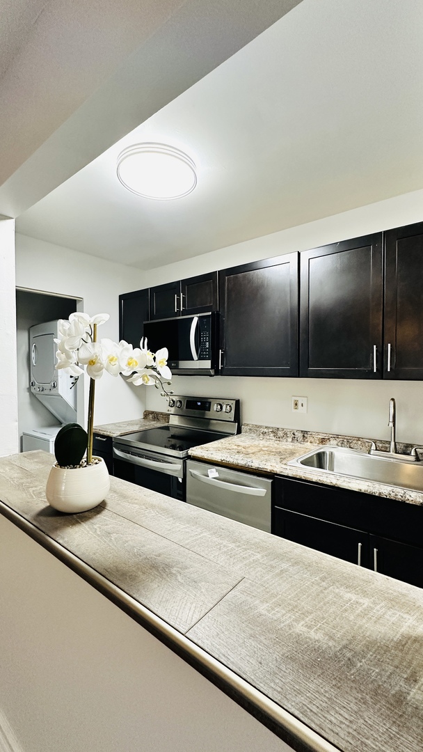 2014 North Rand Road, Unit 108 Palatine, IL 60074 - Photo 6 of 16 a kitchen with kitchen island sink stainless steel appliances and cabinets