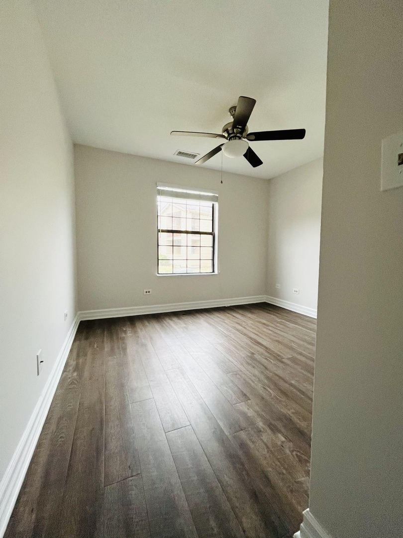 2014 North Rand Road, Unit 108 Palatine, IL 60074 - Photo 10 of 16 an empty room with wooden floor and windows