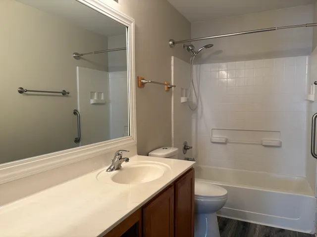 a bathroom with a sink toilet and shower