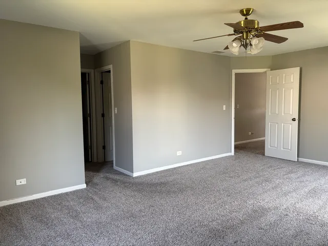 a bathroom with a granite countertop shower sink vanity and a mirror