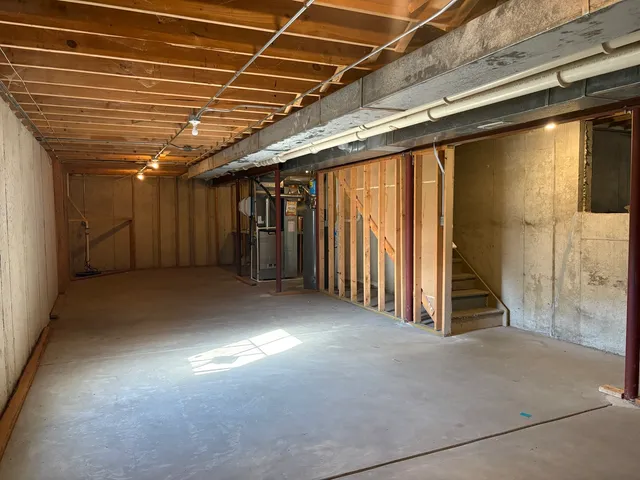 a view of an empty room with a ceiling fan and window