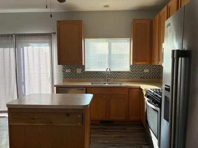 a kitchen with a sink and refrigerator