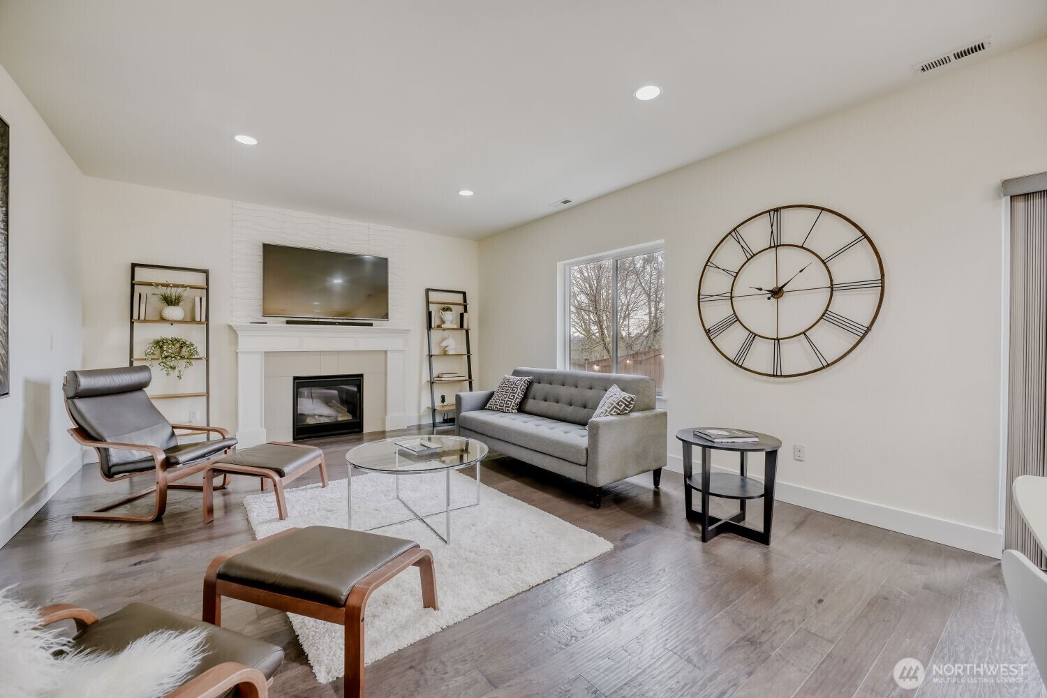 1900 240th Place Southwest Bothell, WA 98021 - Photo 3 of 12 a living room with furniture a fireplace and a flat screen tv