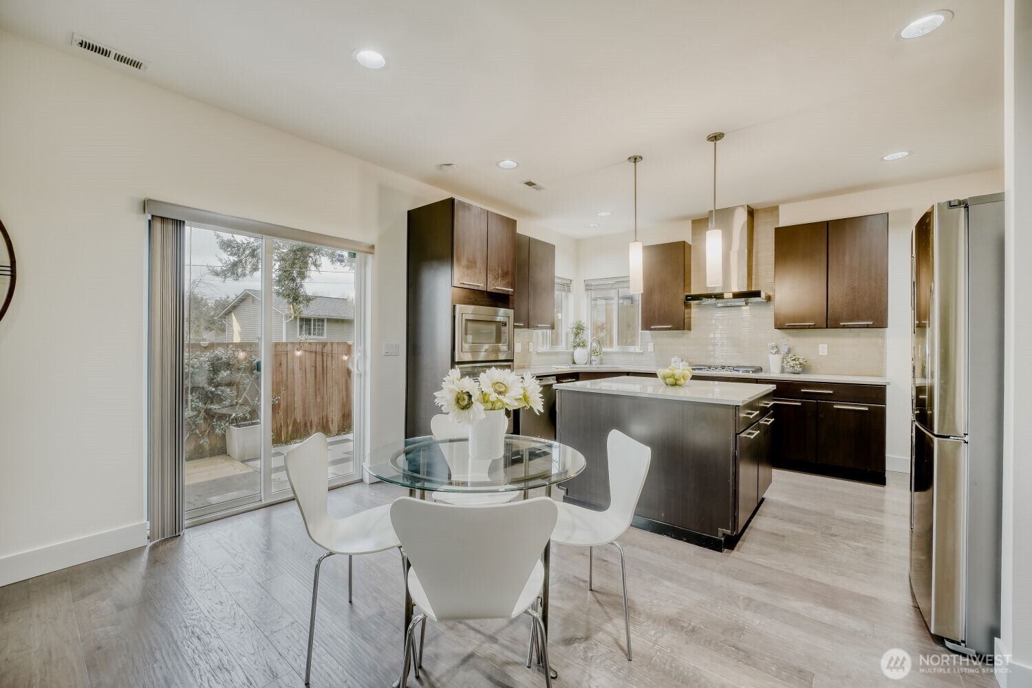 1900 240th Place Southwest Bothell, WA 98021 - Photo 4 of 12 a kitchen with kitchen island granite countertop a sink cabinets and stainless steel appliances