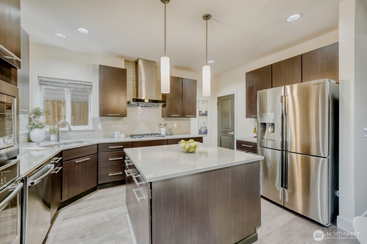 1900 240th Place Southwest Bothell, WA 98021 - Photo 5 of 12 a kitchen with stainless steel appliances granite countertop a sink refrigerator and microwave