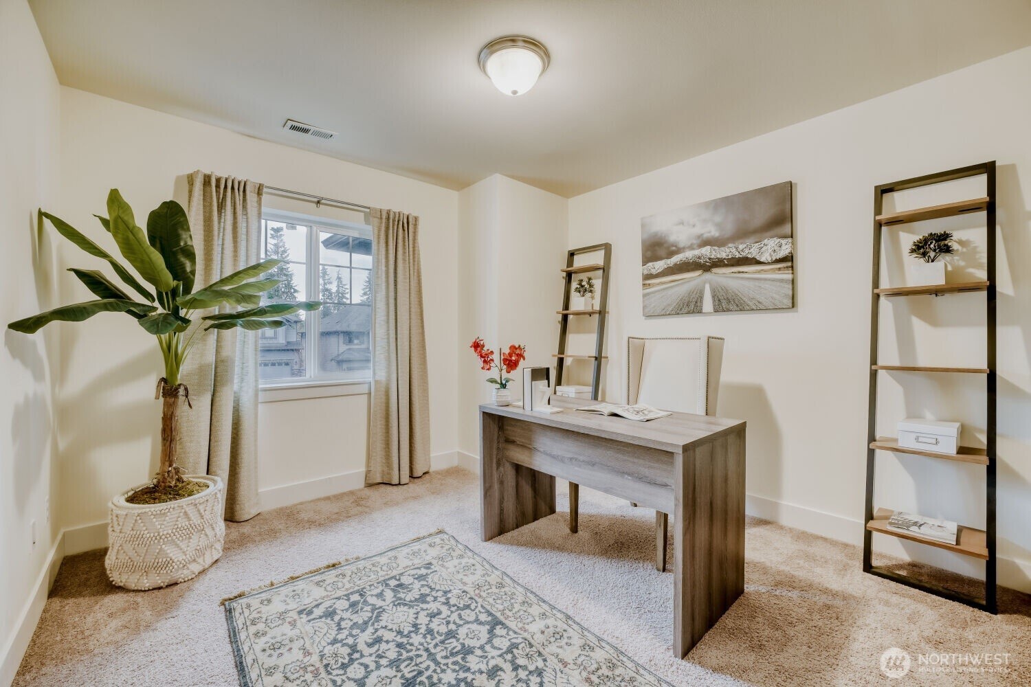 1900 240th Place Southwest Bothell, WA 98021 - Photo 10 of 12 a view of a workspace with furniture and a potted plant